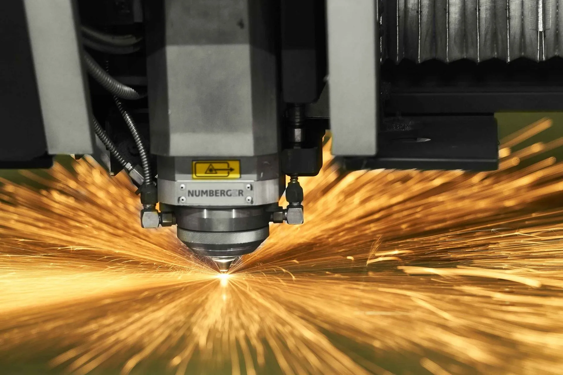 Laser cutting machine at Numberger Technologies with sparks